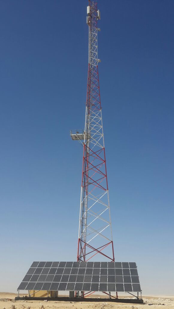 Completed tower with solar panels in the foreground.