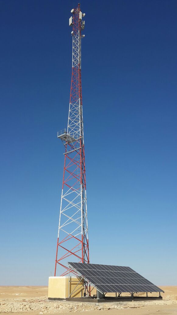 Completed tower with mounted antennas and site infrastructure.