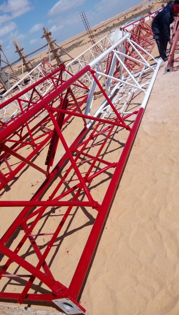Red-and-white tower sections during restoration work.